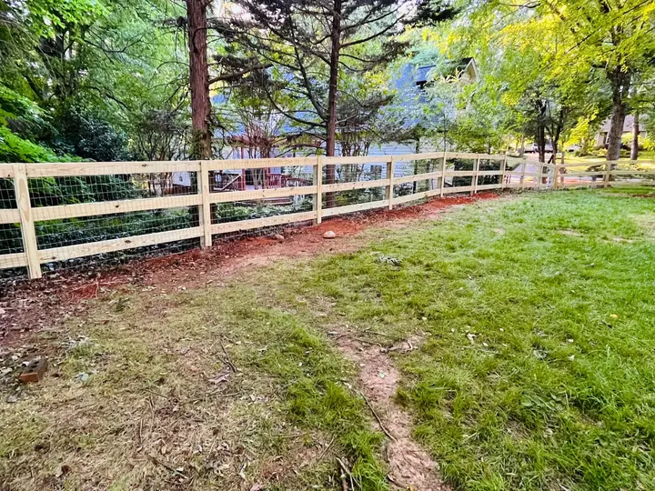 Wood and wire fence enclosing a yard in Matthews, NC